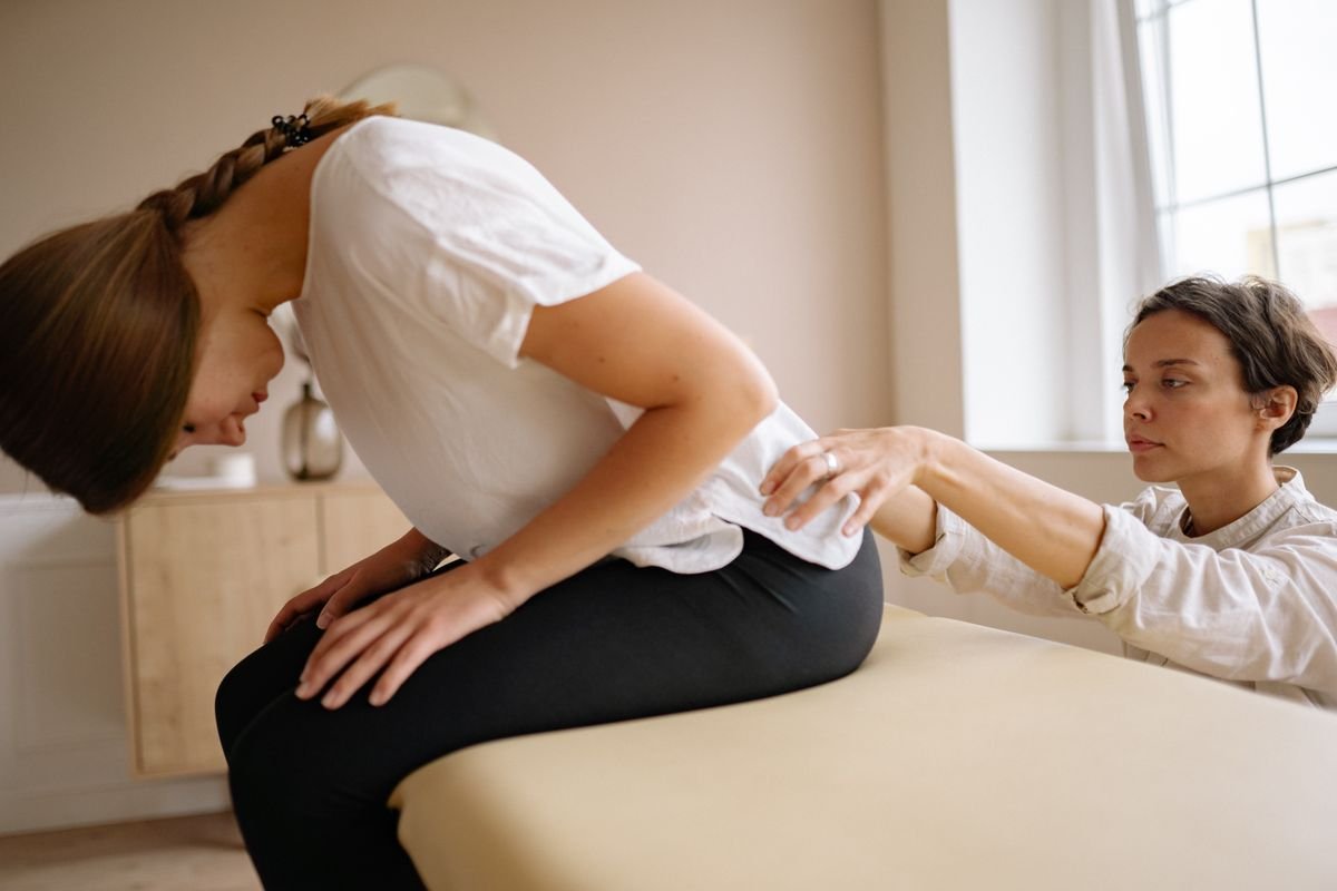 Physiotherapist treating back pain in a desk worker from Kochi